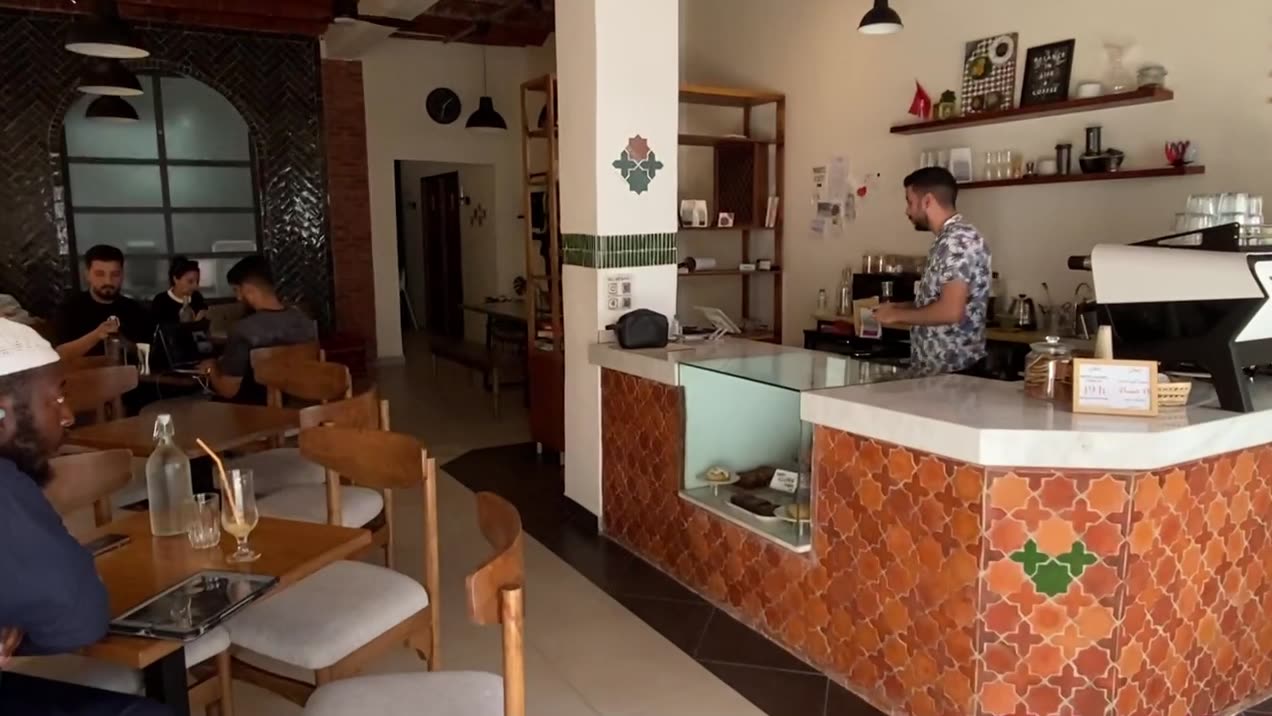 Barista at the tiled counter
